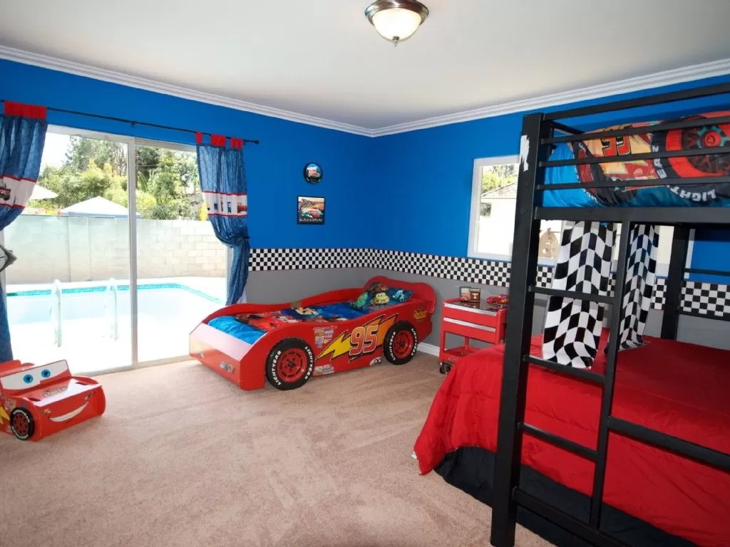Mẫu phòng ngủ rộng có nhiều đồ chơi cho bé trai chọn màu sơn xanh thẫm