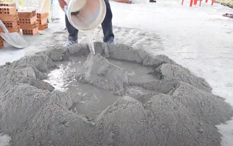 Thêm nước và trộn đều cát xi măng láng nền