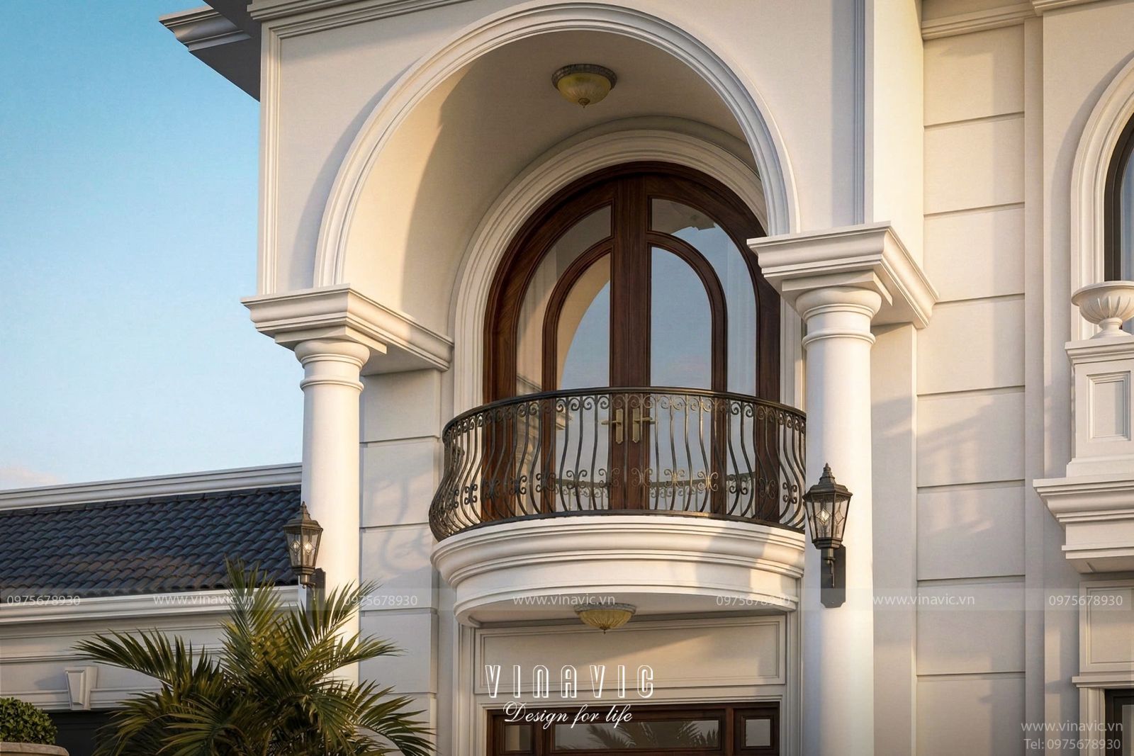 Chi tiết thiết kế ban công vòm cong lan can sắt mỹ thuật và hệ cửa gỗ gõ đỏ tầng 2 của mẫu biệt thự tân cổ điển BT2460.